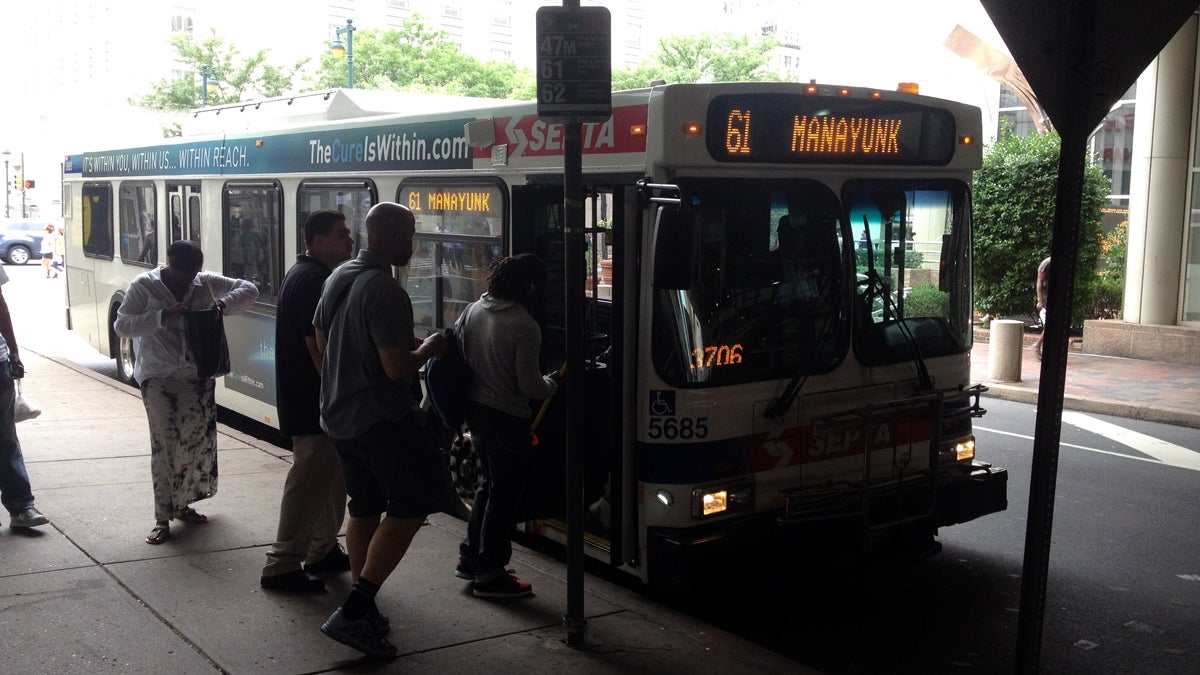  Passengers board the Manayunk-bound 61 bus at Market and 9th streets in Center City. (Eric Walter/WHYY) 