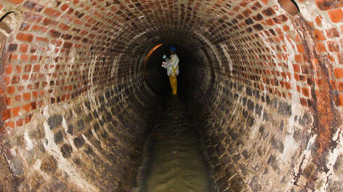 Wastewater pipeline infrastructure in Pennsylvania is old and in some cities pollutes rivers.  In Philadelphia about half of the wastewater system has brick piping. John Key Junior inspects a sewer in Philadelphia, Pa. (Kimberly Paynter/WHYY) 