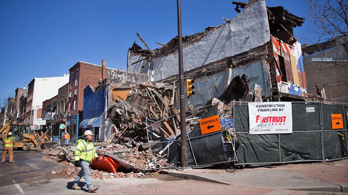 Brick and debris landed in the street after a side wall collapsed during the demolition of the Shirt Corner on 3rd and Market Streets Thursday afternoon (Lindsay Lazarski/WHYY)  