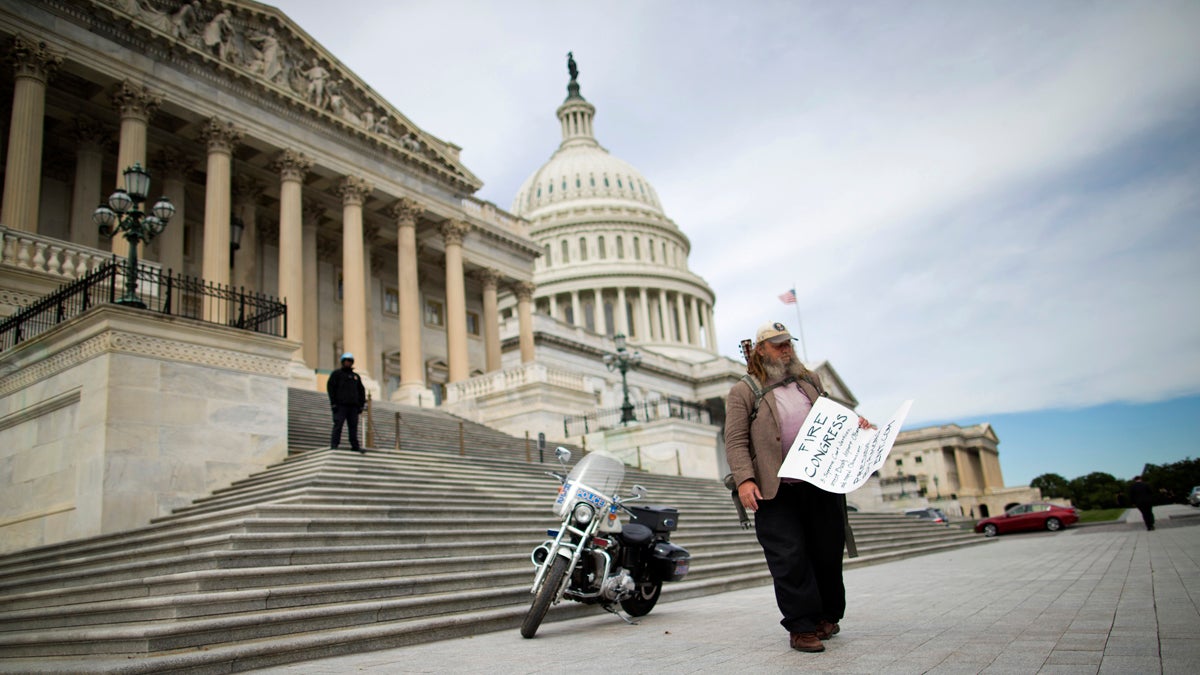  Rick Hohensee of Washington holds a 'Fire Congress' sign near the House steps on Capitol Hill in Washington, Tuesday, Oct. 8, 2013 (Evan Vucci/AP Photo) 
