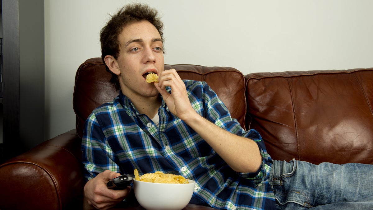  (<a href='http://www.shutterstock.com/pic-127777754/stock-photo-young-man-on-couch-eating-potato-chips.html'>Young man on the couch image</a> courtesy of Shutterstock.com) 