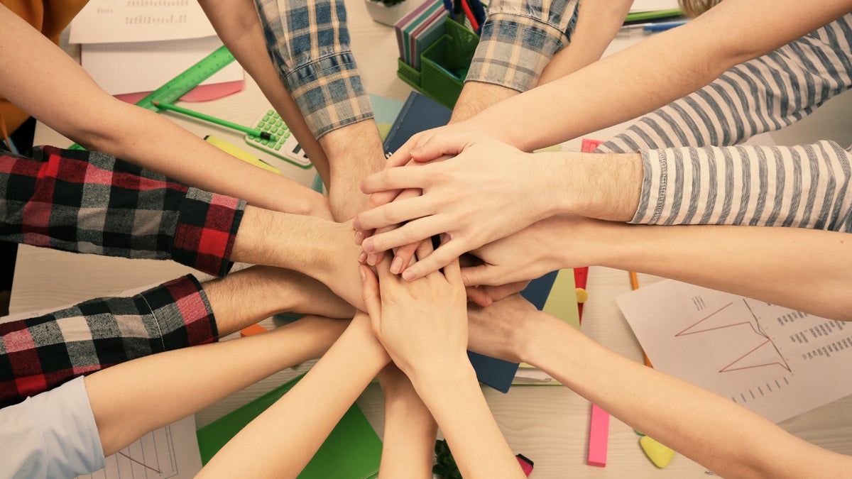  (<a href=`http://www.shutterstock.com/pic-298084979/stock-photo-united-hands-of-business-team-on-workspace-background-top-view.html'>Friends at work</a> image courtesy of Shutterstock.com) 