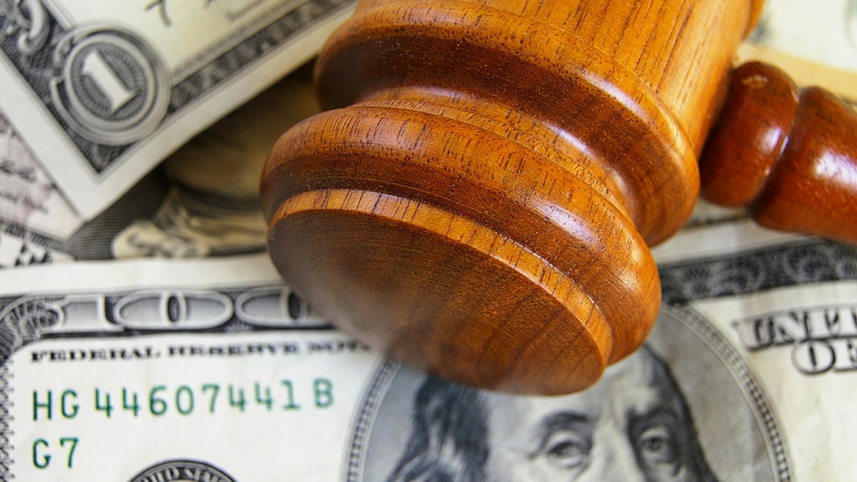 (<a href='http://www.shutterstock.com/pic-99045299/stock-photo-closeup-of-a-gavel-on-cash-from-above.html'>Image</a> courtesy of Shutterstock.com) 