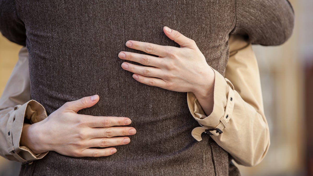  (<a href='http://www.shutterstock.com/pic-223911598/stock-photo-adult-couple-standing-on-street-and-hugging-closeup-of-woman-hands-hugging-man-outside.html?src=csl_recent_image-1'>Hug</a> image courtesy of Shutterstock.com) 