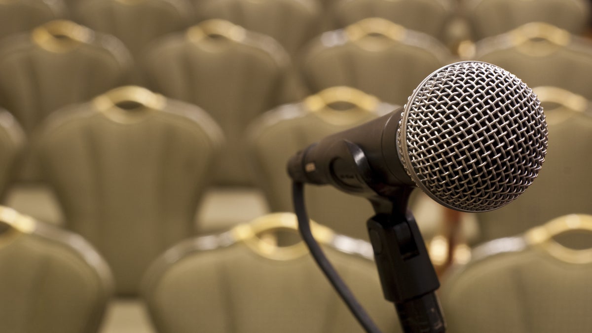  (<a href='http://www.shutterstock.com/pic-79228525/stock-photo-microphone-in-front-of-several-rows-of-empty-chairs-with-shallow-depth-of-field.html'>Microphone</a> image courtesy of Shutterstock.com) 
