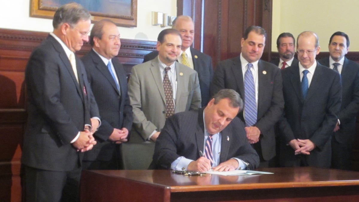 New Jersey Gov. Chris Christie signs legislation Monday adding 29 more judges to the bench to help the state carry out criminal justice system changes. (Phil Gregory/WHYY)