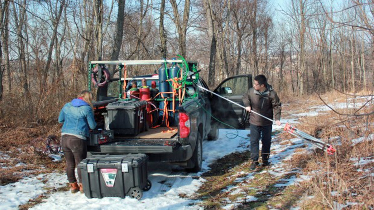 Researchers Xiang Lee and Melissa Sullivan prepare to measure methane from a well site in Monroeville Community Park. (Susan Phillips/StateImpact Pennsylvania)