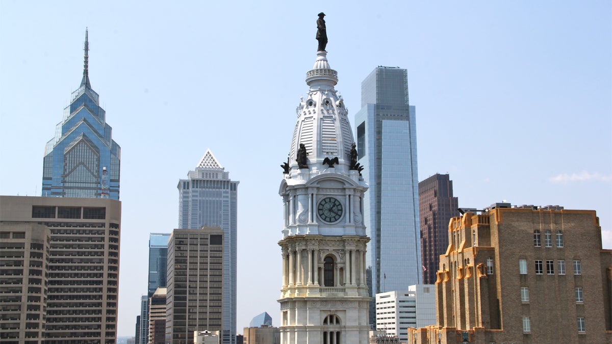  A statue of William Penn atop Philadelphia's City Hall can be seen in the forefront of a portion of the city's skyline (NewsWorks Photo, file) 