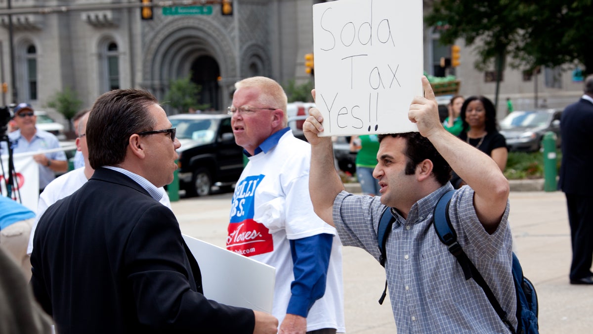 A soda tax supporter outside City Hall in Philadelphia (NewsWorks file photo)