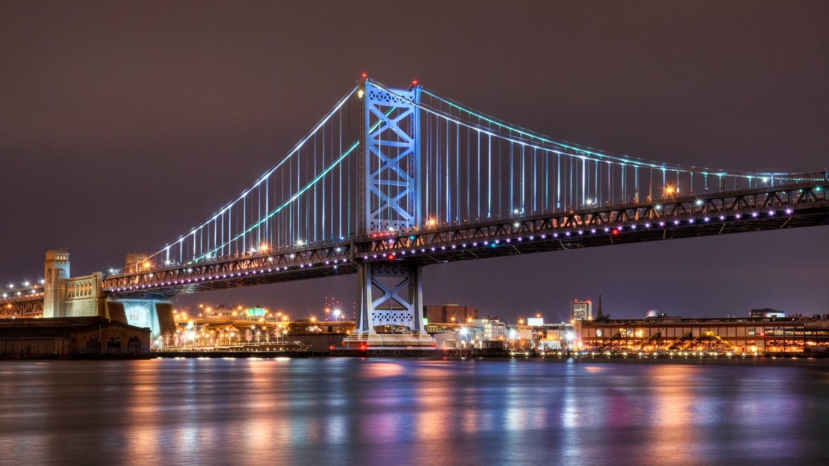  The Ben Franklin Bridge illuminated over the Delaware River. (Photo via Shutterstock) 