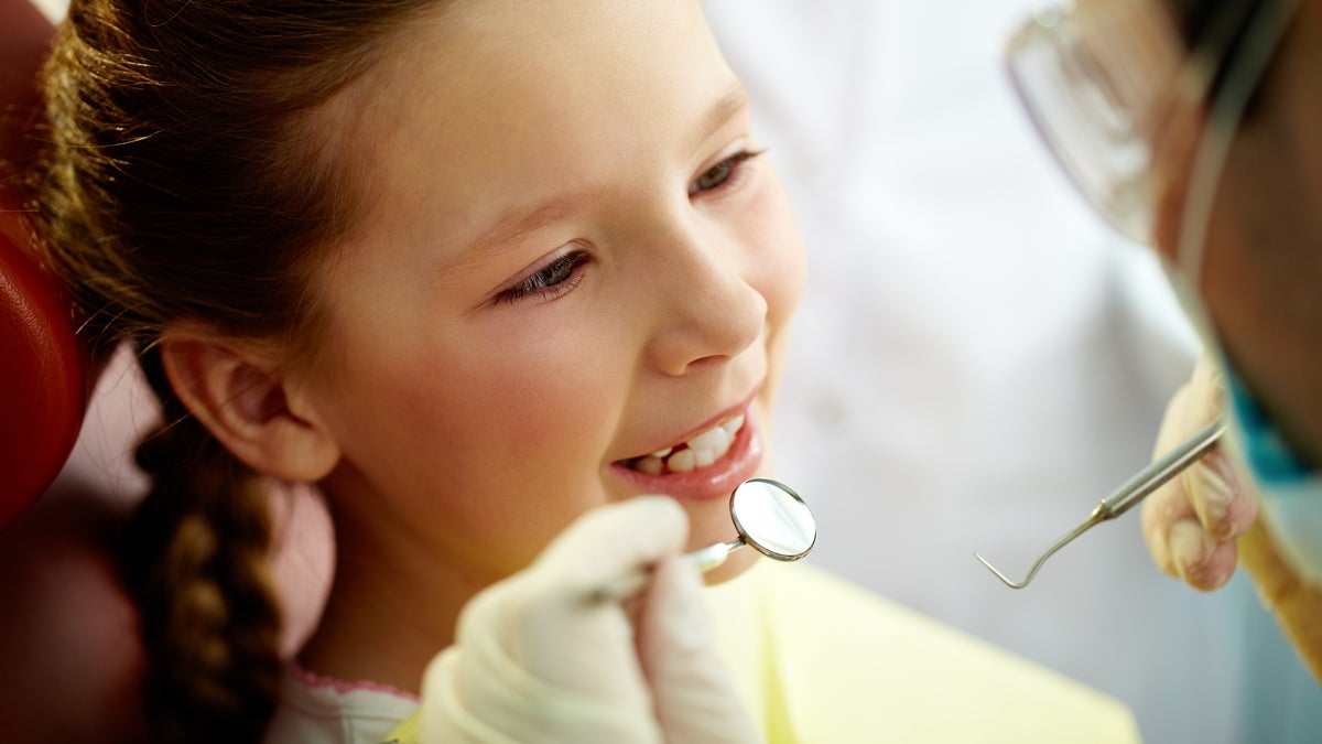  (<a href=“http://www.shutterstock.com/pic-99581816/stock-photo-close-up-portrait-of-a-little-smiling-girl-at-dentist-s-office.html?src=WmWycw1ykzkLxfs-gQmFRw-1-65”>Photo</a> via ShutterStock)  