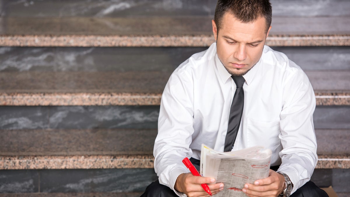  (<a href=“http://www.shutterstock.com/pic-226044718/stock-photo-young-unemployed-man-is-looking-for-a-job-in-the-newspaper-sitting-on-the-stairs.html?src=r94XmR_v4YsYw6RXkZnTww-1-2