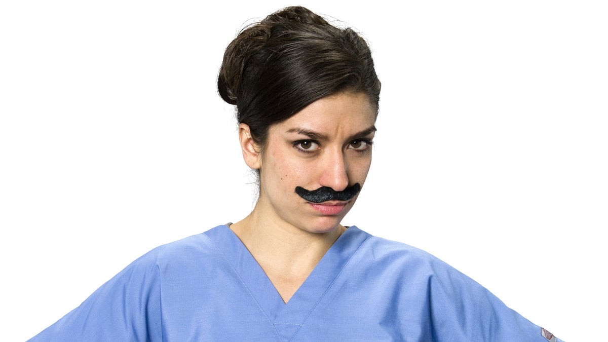  (<a href=“http://www.shutterstock.com/pic-340784510/stock-photo-serious-caucasian-young-woman-dark-brown-in-uniform-using-fake-mustache-isolated.html?src=MhreTbF9SAwYPWH8WByLxw-1-2”>Photo</a> via ShutterStock) 