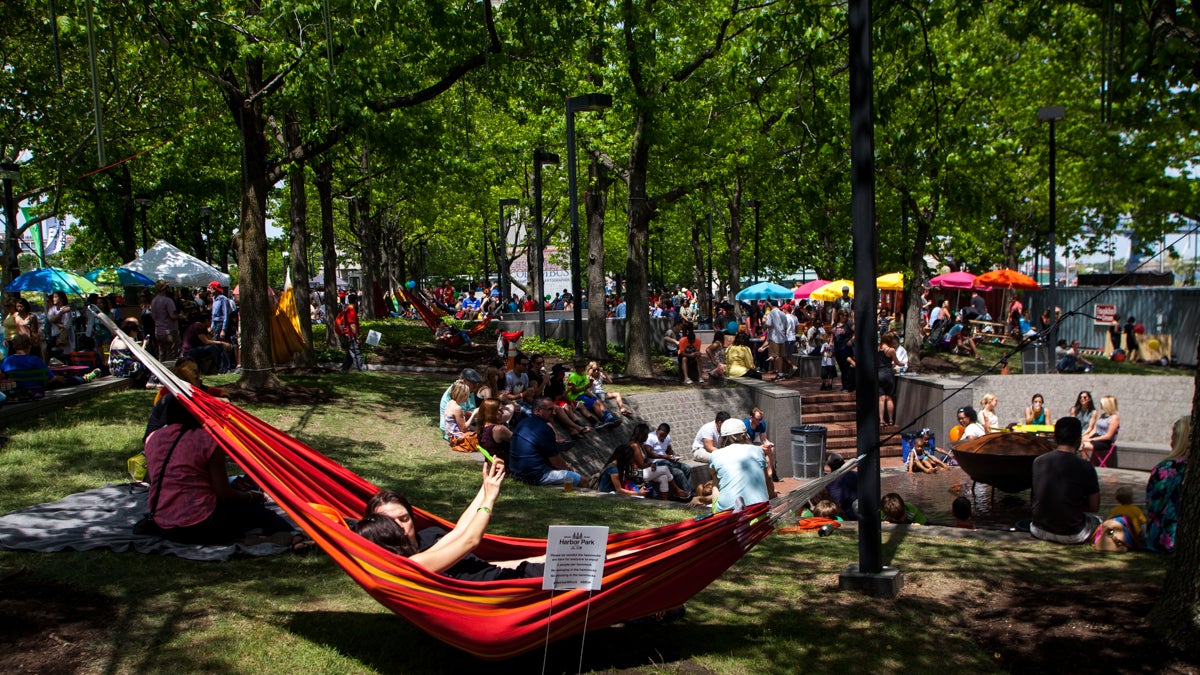 A couple takes a selfie in a hammock during opening weekend at Spruce Street Harbor Park. (Brad Larrison/for NewsWorks)