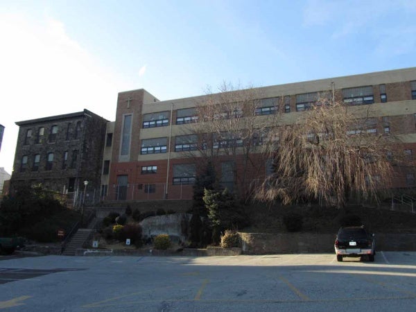  A plan to turn the St. Bridget school into a 32-unit apartment building was first proposed in November. (Megan Pinto/WHYY, file) 