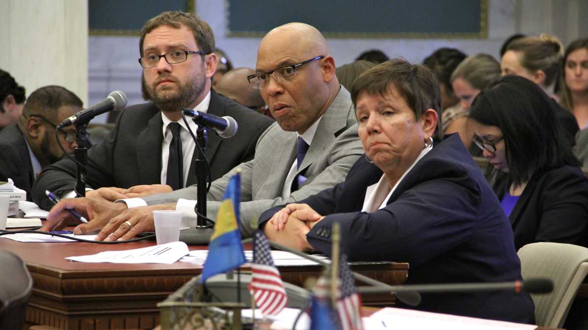  Among the high ranking administrators to leave the Philadelphia School District is Chief Financial Officer Matthew Stanski, left, shown here at a City Hall budget hearing with Superintendent William Hite and SRC Chair Marjorie Neff. (NewsWorks file photo) 