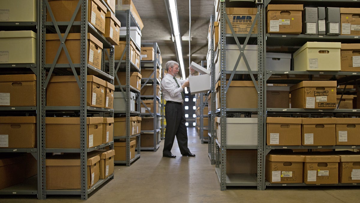  David Carmichael, director of Pennsylvania State Archives, looks though one of many boxes that holds permanent pension records in Harrisburg, Pa. (Lindsay Lazarski/WHYY) 