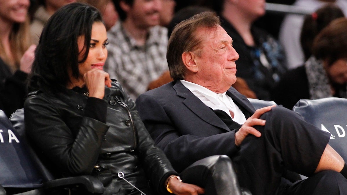  LA Clippers owner Donald Sterling, right, with V. Stiviano, the woman who taped the phone conversation, left. (Danny Moloshok/AP Photo) 