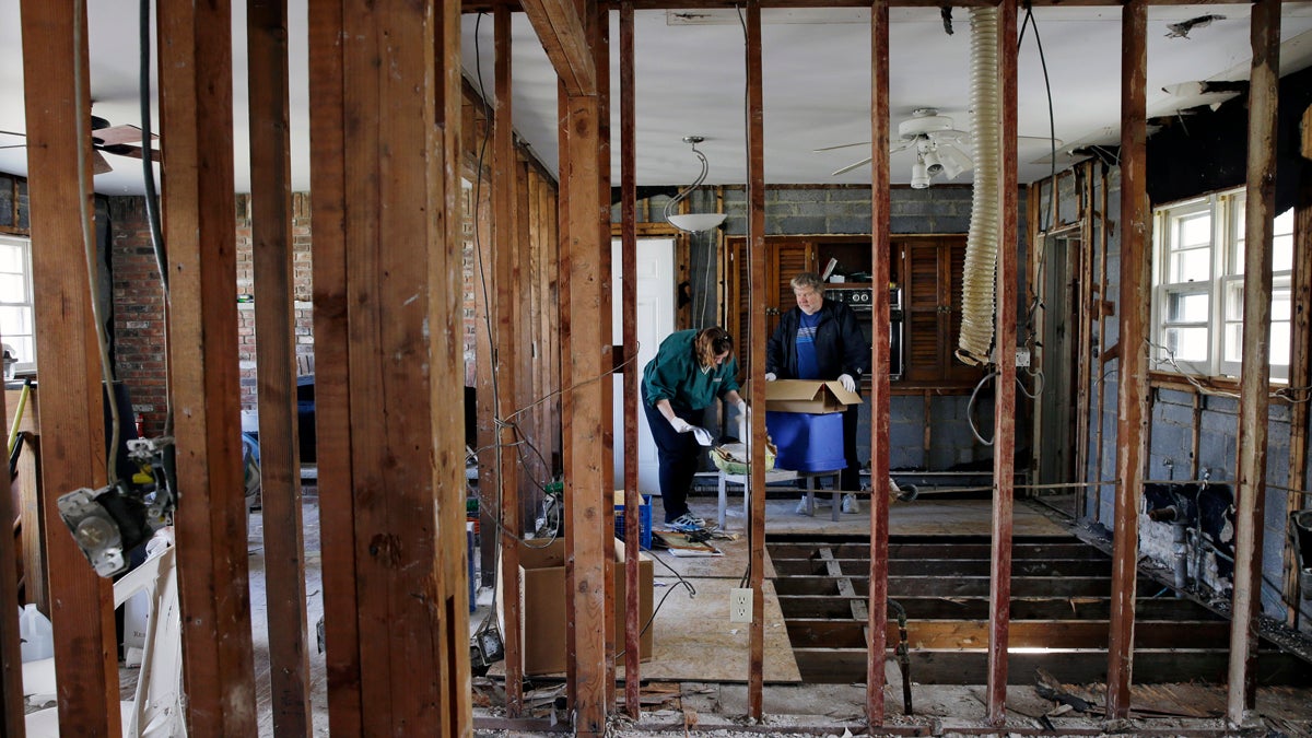  Lee Ann Newland and husband John Lambert, sort through items, inside their Sandy damaged home near the Shark River in Neptune, N.J. (AP Photo/Mel Evans, file) 