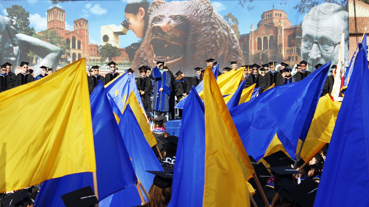 UCLA student-athletes and scholars carry 99 flags at a commencement ceremony in 2010. (AP Photo/Reed Saxon