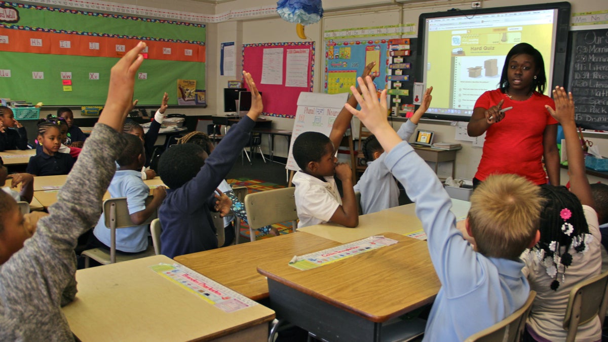 Second-graders raise their hands at Chester Arthur Elementary School. (Emma Lee/WHYY