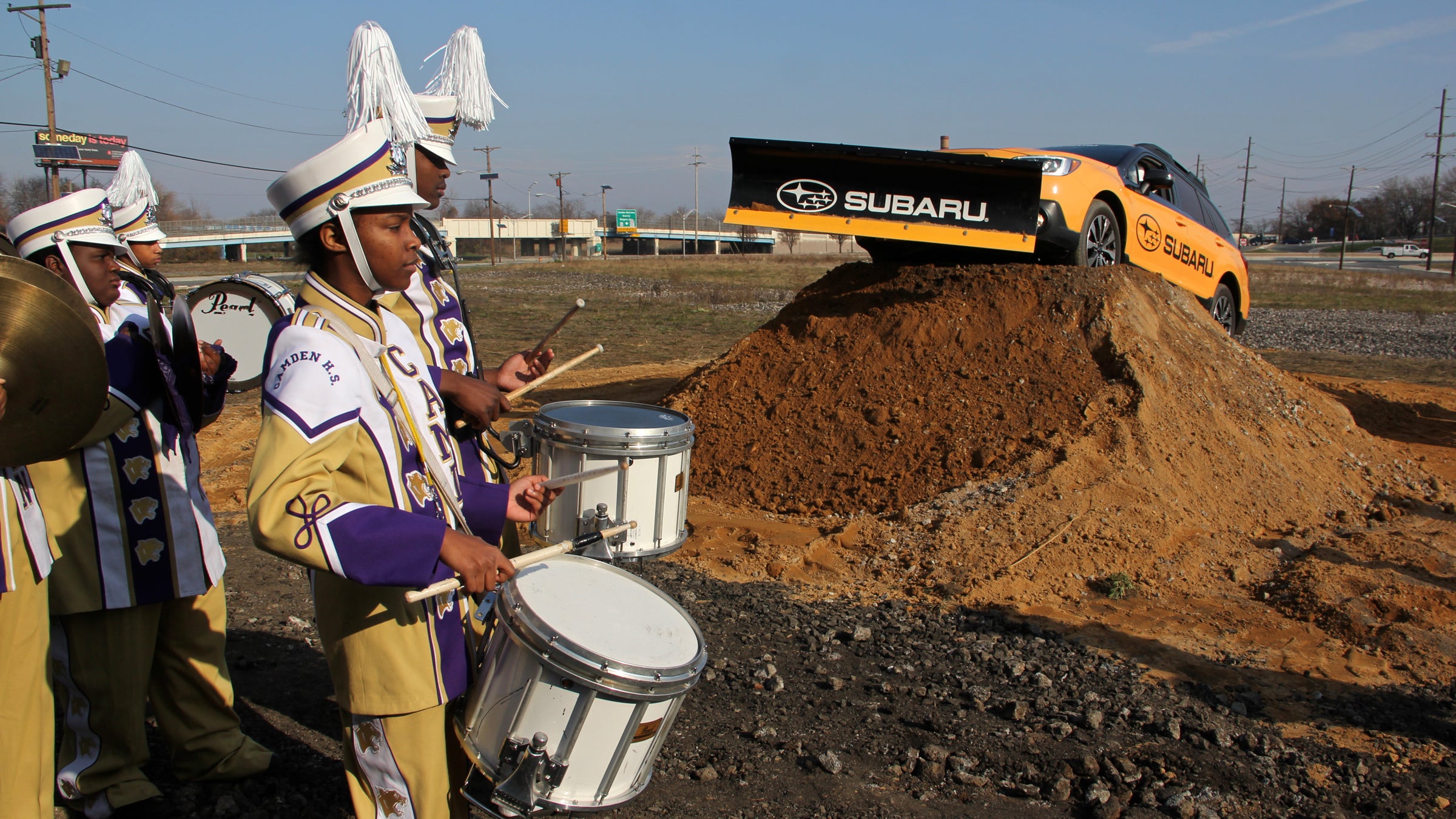 Members of the Camden High School marching band play while Subaru America ceremoniously breaks ground for its new headquarters. (Emma Lee/WHYY)