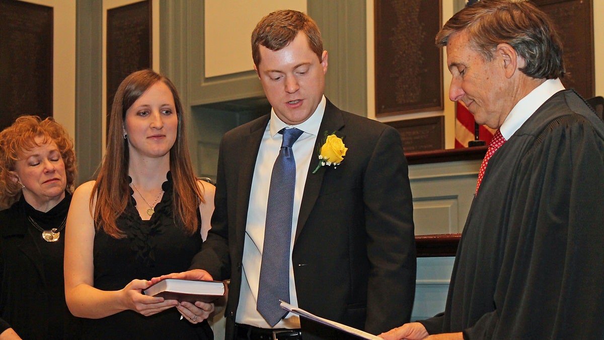  Rep. David Bentz takes the oath of office adminstered by Delaware Supreme Court Justice Randy Holland. Bentz's wife Sara holds the Bible. (photo courtesy Doug Denison) 