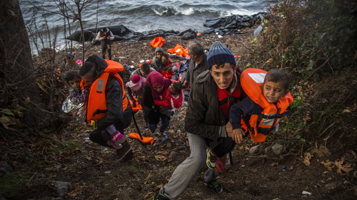  Syrian refugees climb up to a field after arriving from Turkey at the Greek island of Lesbos on an overcrowded dinghy, Tuesday, Oct. 27, 2015. Greece’s government says it is preparing a rent-assistance program to cope with a growing number of refugees, who face the oncoming winter and mounting resistance in Europe. (AP Photo/Santi Palacios) 