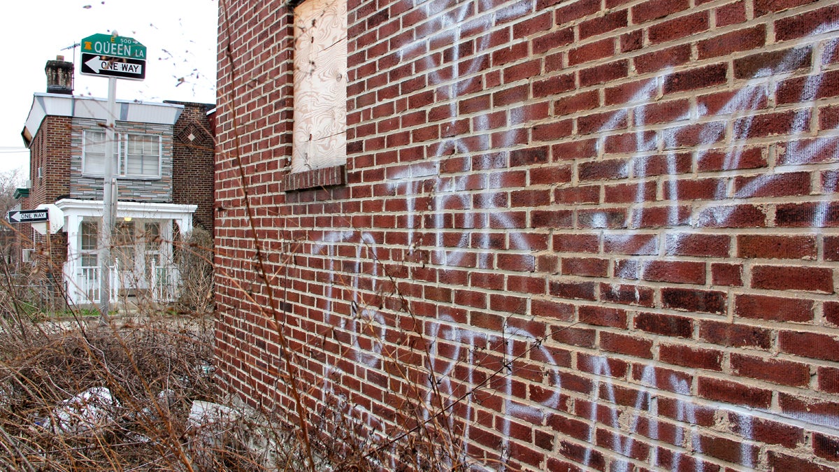  A vacant home stands tagged by graffiti on Queen Lane at West Clarkson Avenue. (Emma Lee/for NewsWorks) 