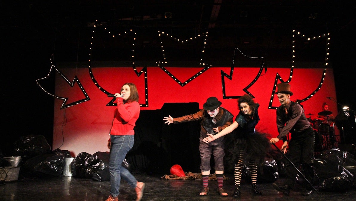  Jess Conda plays Shirley, left, and is seduced by three vagabond clowns played by Rob Cutler, Tabitha Allen, and Justin Rose in Always Coming Soon: The Future. (Kimberly Paynter/WHYY) 