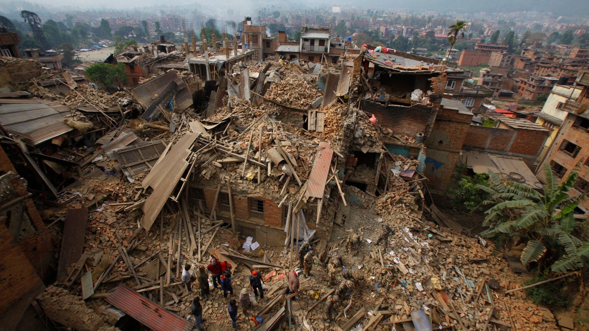 Rescue workers remove debris as they search for victims of earthquake in Bhaktapur near Kathmandu
