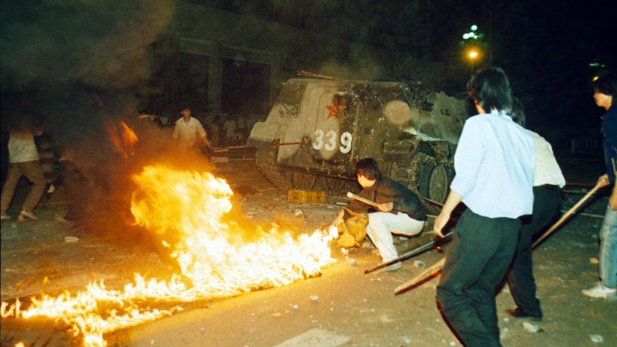  Student protesters are shown putting a barricade in front of a burning armored personnel carrier that rammed through student lines, June 4, 1989. Many were injured and killed during an army attack on pro-democracy demonstrators in Beijing's Tienanmen Square. (AP Photo, file) 