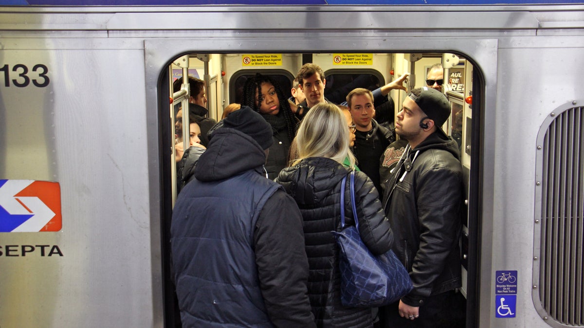 train cracks II Commuters crowd a Market Frankford El train. (Emma Lee/WHYY)