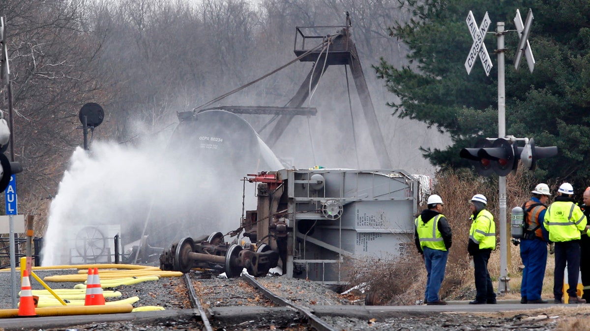 Crews spray water on derailed freight train tank cars in Paulsboro