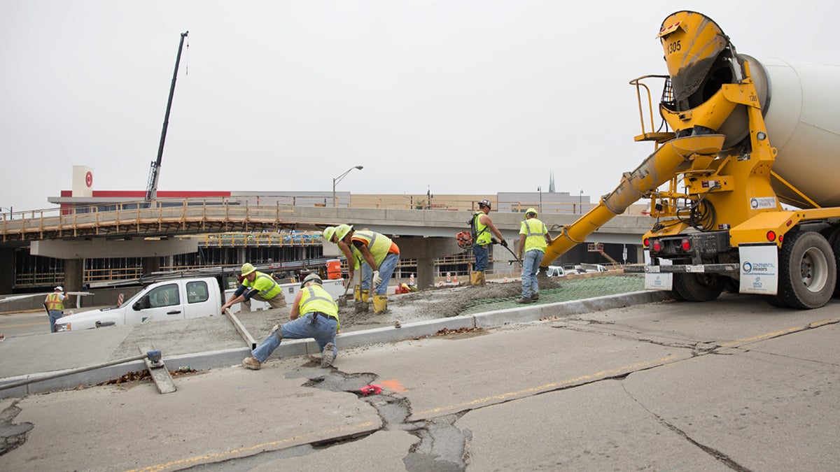  Construction workers pour concrete near the East Liberty transit station in Pittsburgh, Pa. (Lindsay Lazarski/WHYY) 