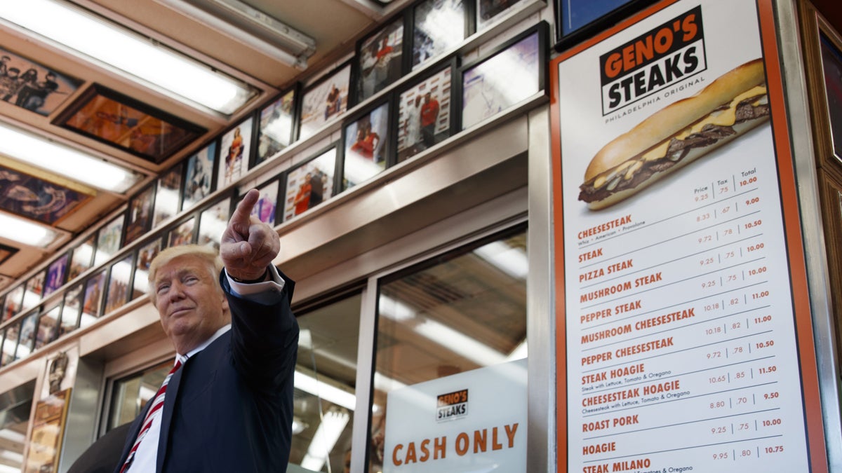 Republican presidential candidate Donald Trump talks with customers during a visit to Geno's Steaks