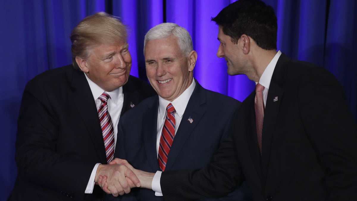 President Donald Trump with Vice President Mike Pence shakes hands with House Speaker Paul Ryan at the Republican congressional retreat in Philadelphia