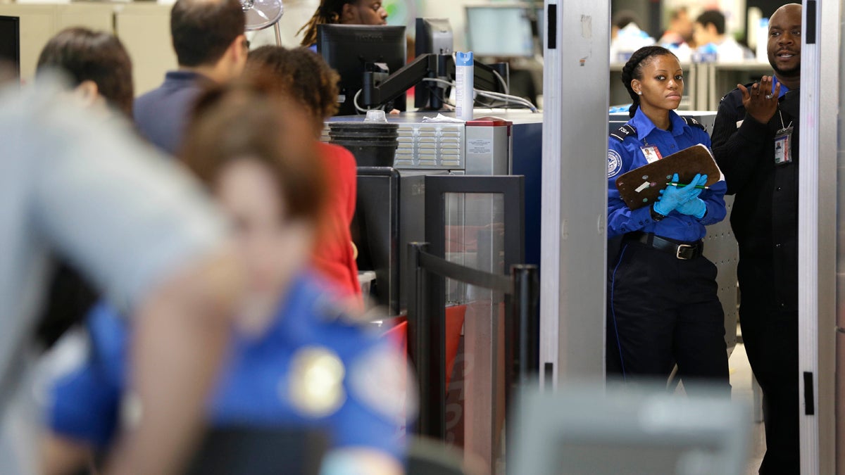 Transportation and Security Administration workers screen passengers. After October 2020, a Pennsylvania driver's license will not be enough identification to board a plane. (Charles Dharapak/AP Photo) 