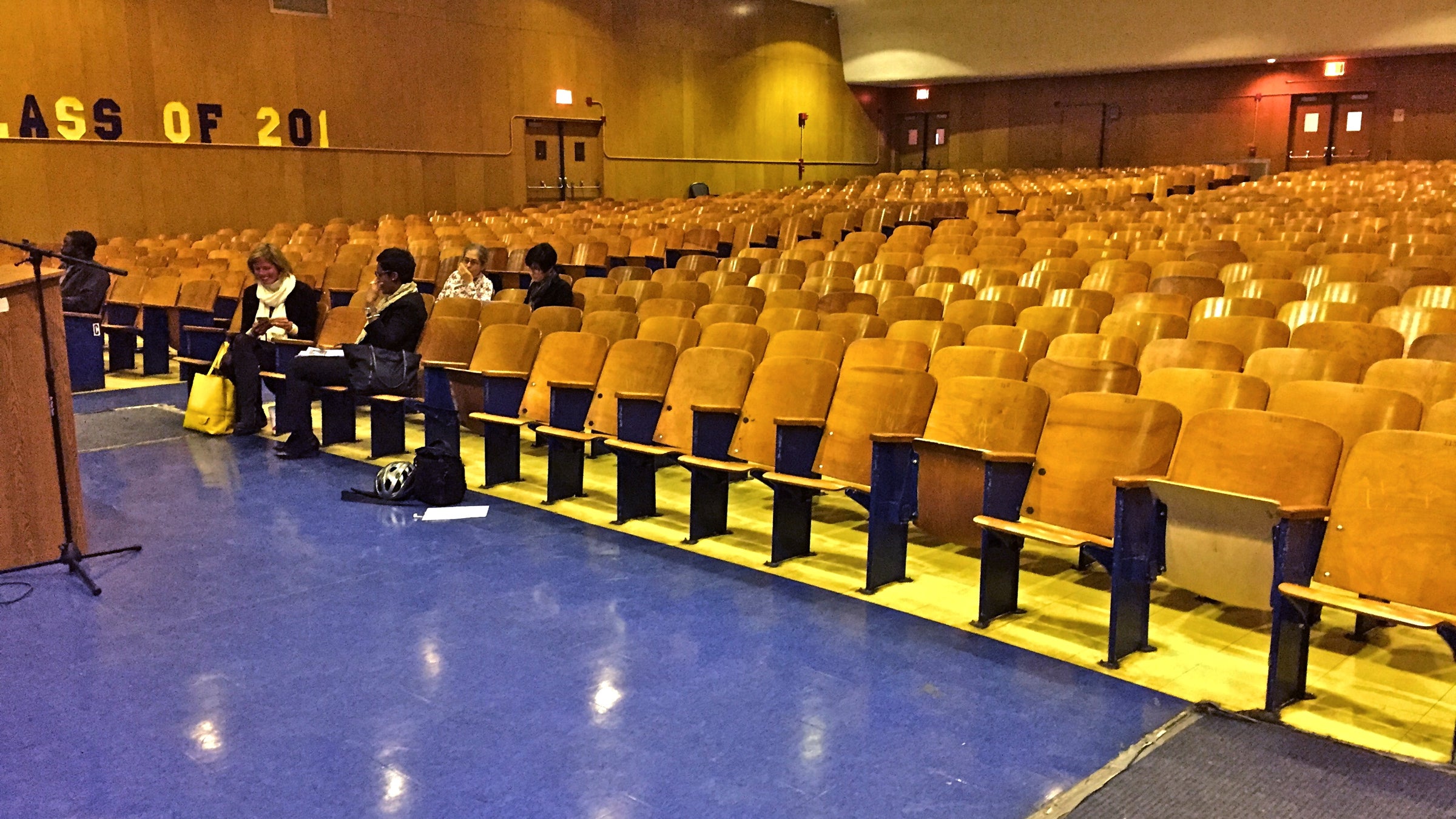 A handful of community members take seats in the Benjamin Franklin High School auditorium to learn about turnaround plans for the school. (Avi Wolfman-Arent/WHYY)