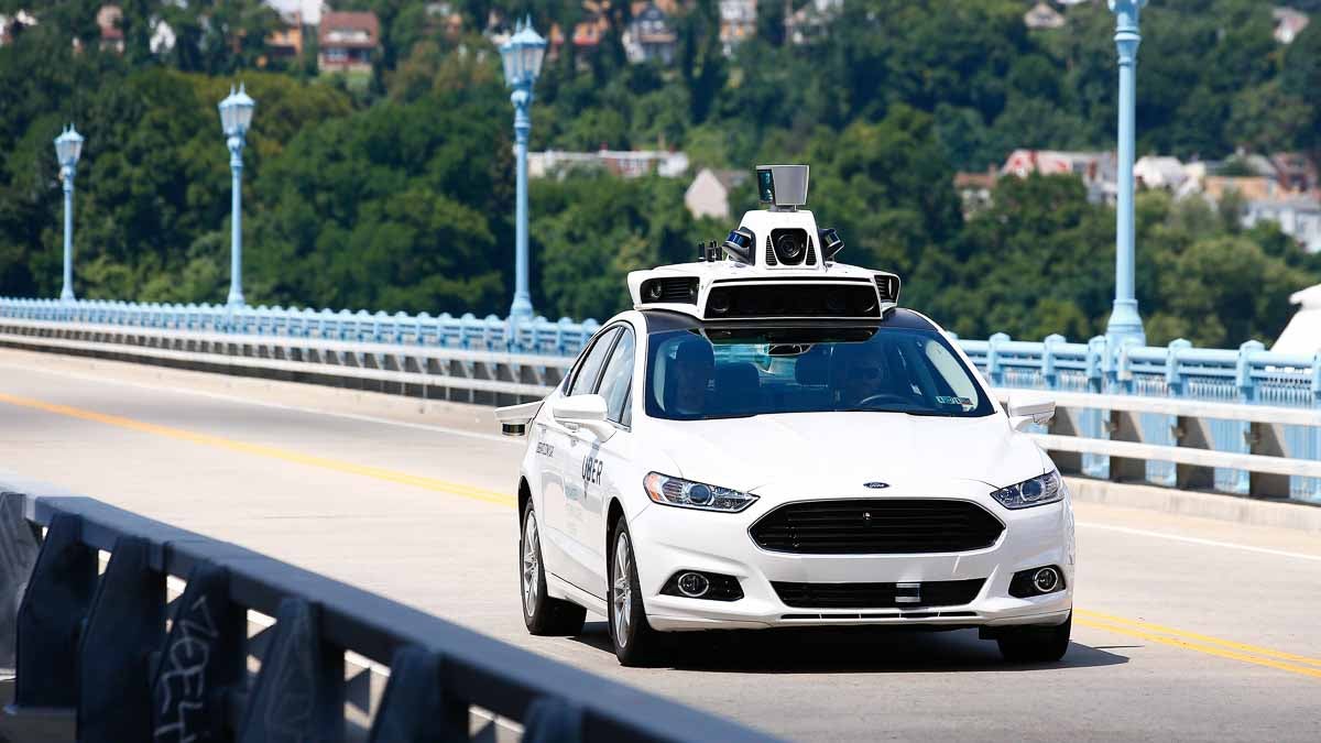 Uber employees test the self-driving Ford Fusion hybrid cars in Pittsburgh. (AP Photo/Jared Wickerham)
