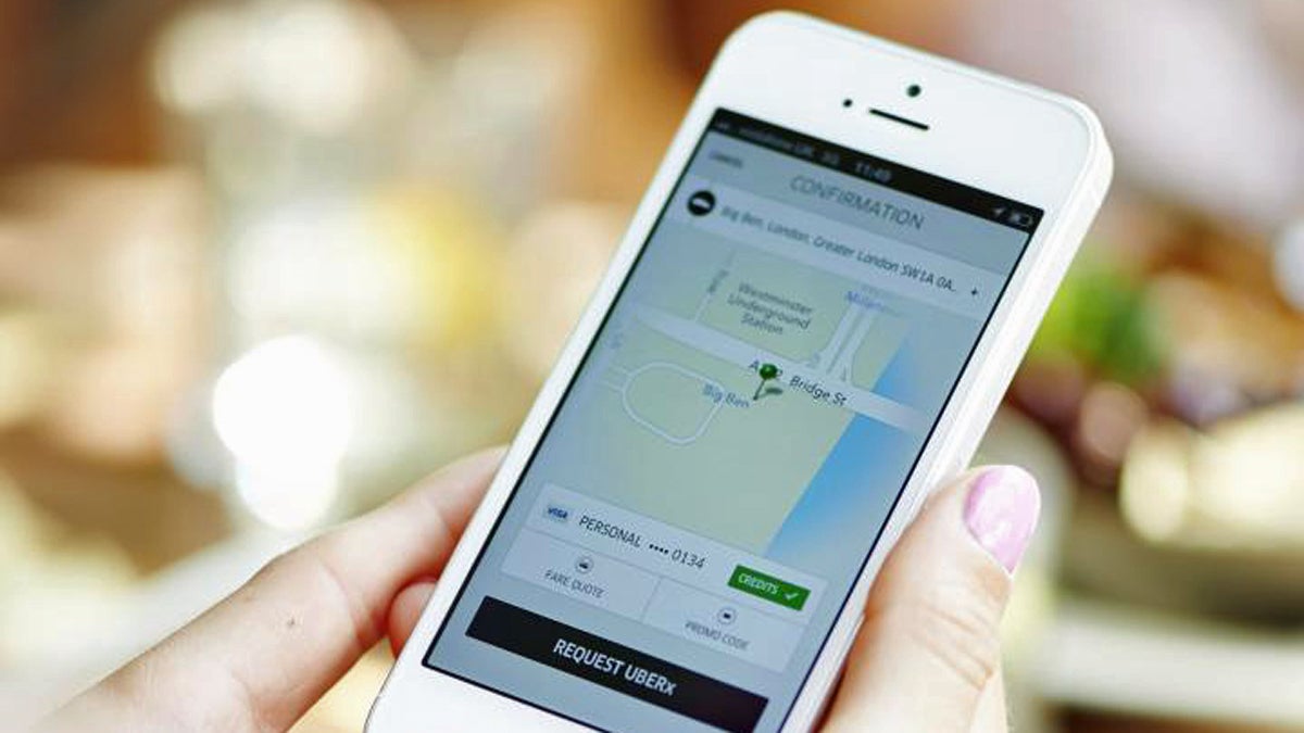  A model demonstrates how to use Uber's app to hail a ride. (Image courtesy of Uber) 