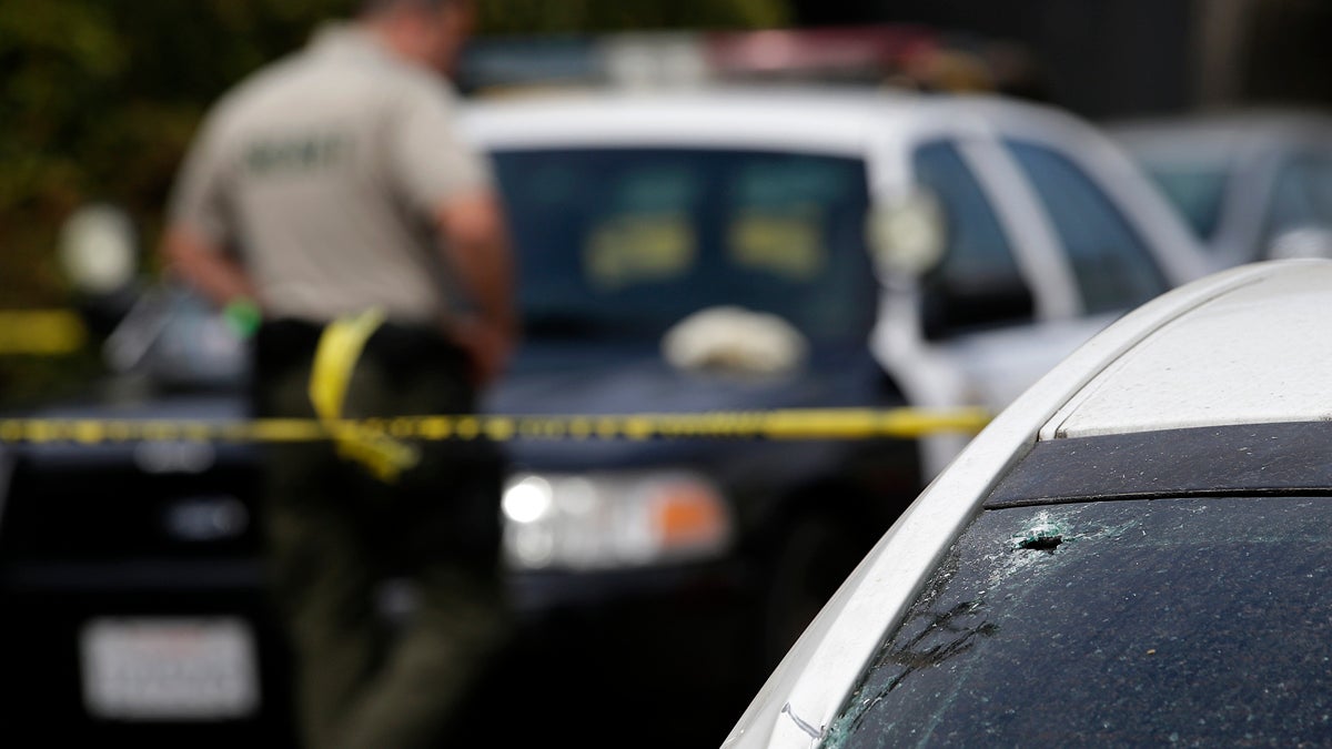  A windshield shattered by a bullet is shown at the scene of a shooting on Saturday, May 24, 2014, in Isla Vista, Calif. A drive-by shooter went on a rampage near a Santa Barbara university campus that left seven people dead, including the attacker, and others wounded, authorities said Saturday. (AP Photo/Jae C. Hong) 