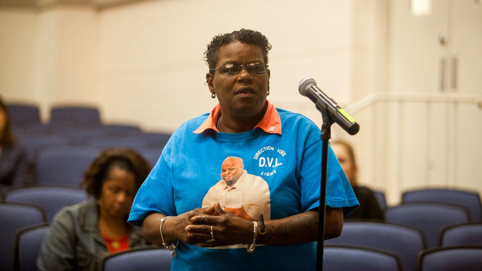 Delphine Matthews speaks at a listening session between the DOJ and residents of Chester. On her shirt is a picture of her son