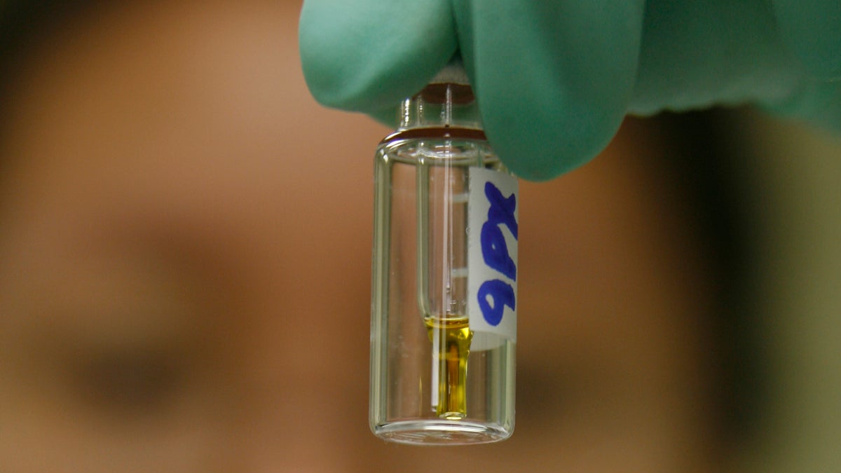  A laboratory chemist checks a vial with a urine sample. (AP Photo/Damian Dovargane, file) 