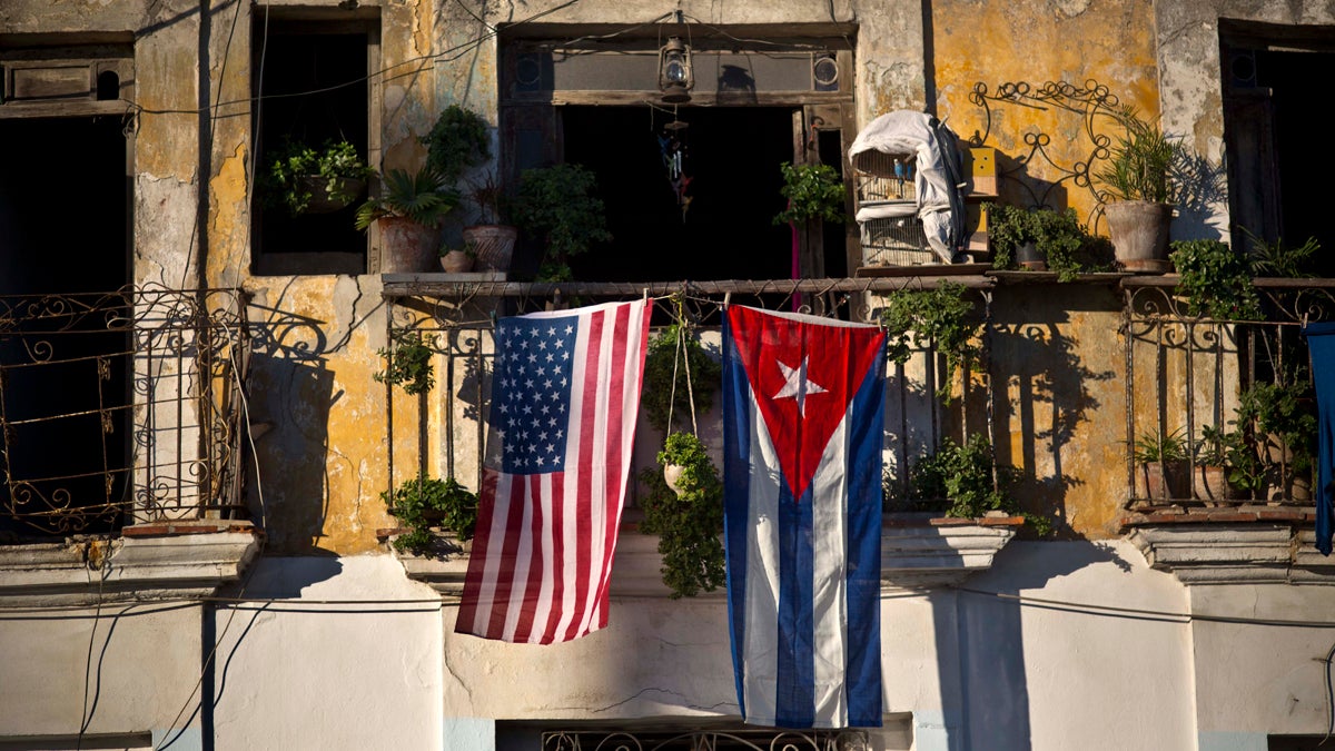  A U.S. and Cuban flag hang from the same balcony in Old Havana, Cuba, Friday, Dec. 19, 2014. After the surprise announcement on Wednesday of the restoration of diplomatic ties between Cuba and the U.S., many Cubans expressed hope that it will mean greater access to jobs and the comforts taken for granted elsewhere, and lift their struggling economy. However others feared a cultural onslaught, or that crime and drugs, both rare in Cuba, will become common along with visitors from the United States. (AP Photo/Ramon Espinosa) 