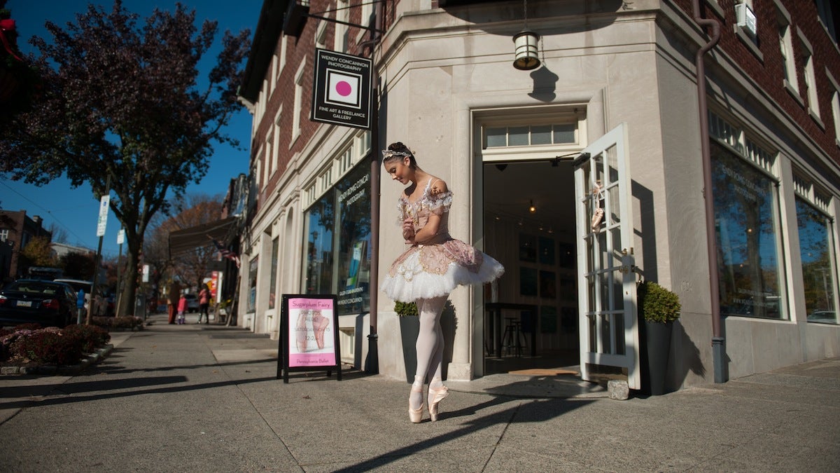 Sugarplum fairy Sara Schaeffer, a student at the School of Pennsylvania Ballet, awaits scavenger hunters participating in Chestnut Hill's The Nutcracker scavenger hunt along Germantown Avenue Saturday afternoon.