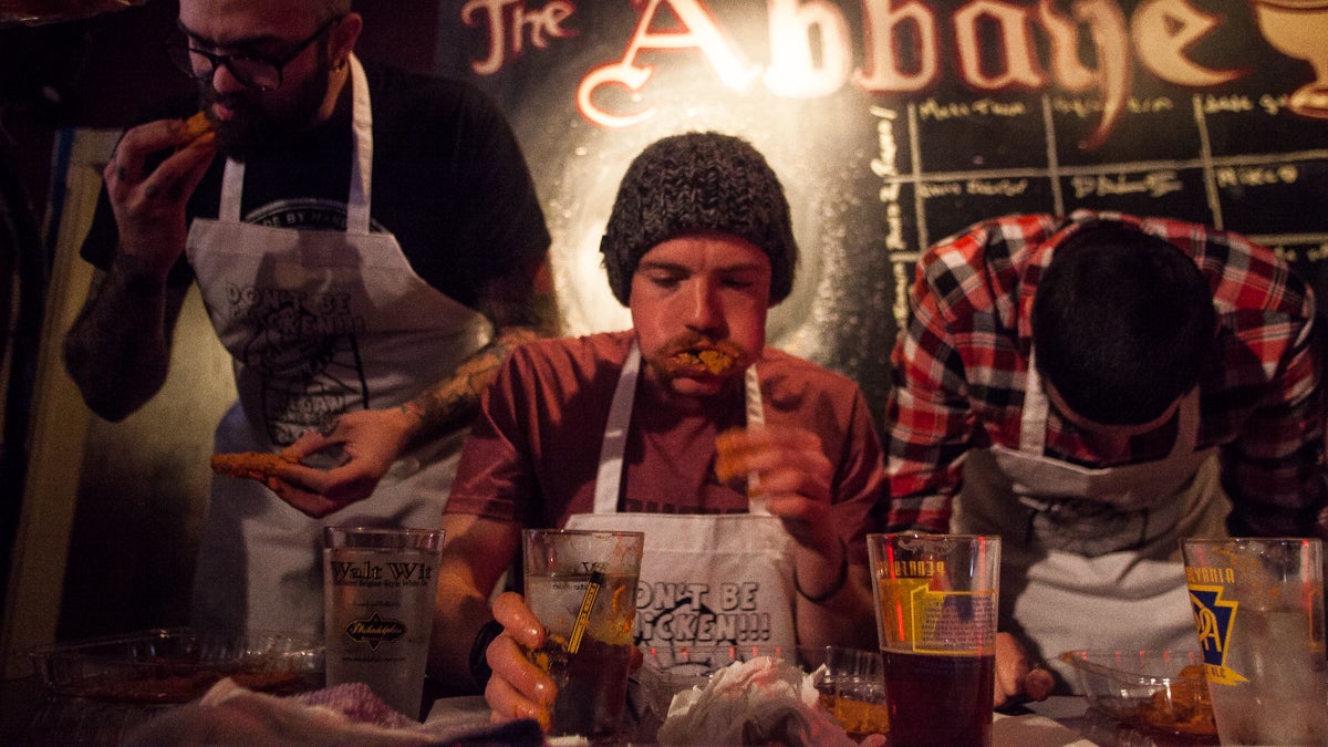 The winner of the Vegan Wing Bowl Brandon Lyman, center, ate 26.8 ounces in the two minutes alotted. (Brad Larrison/for NewsWorks)