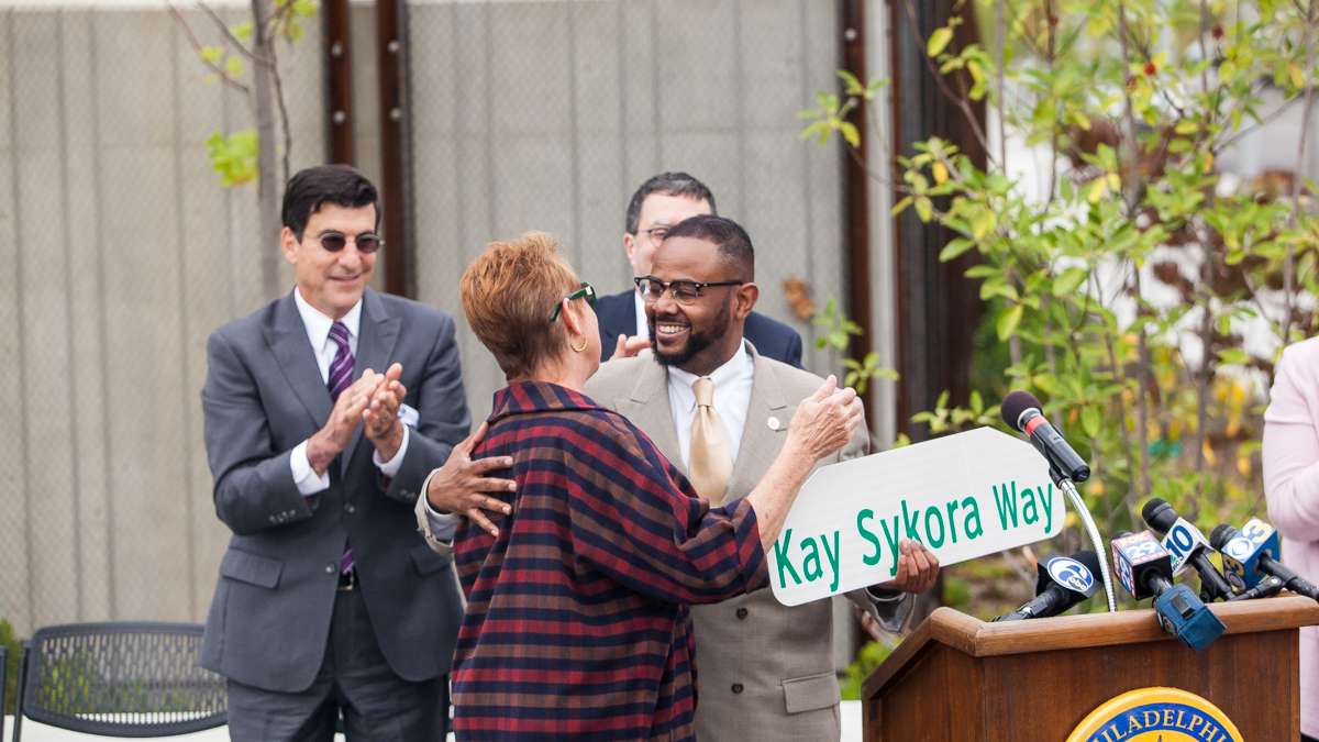 City Councilman Curtis Jones Jr. presented Kay Sykora of the Manayunk Development Corporation with a commemorative street sign honoring her efforts in the transformation of Venice Island. (Brad Larrison/for NewsWorks)