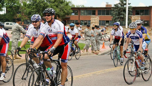  In this 2010 photo, participants ‘Ride 2 Recovery’ in the Rocky Mountain Challenge while active servicemen and women cheer along the riders. (Image courtesy of Ride2Recovery) 