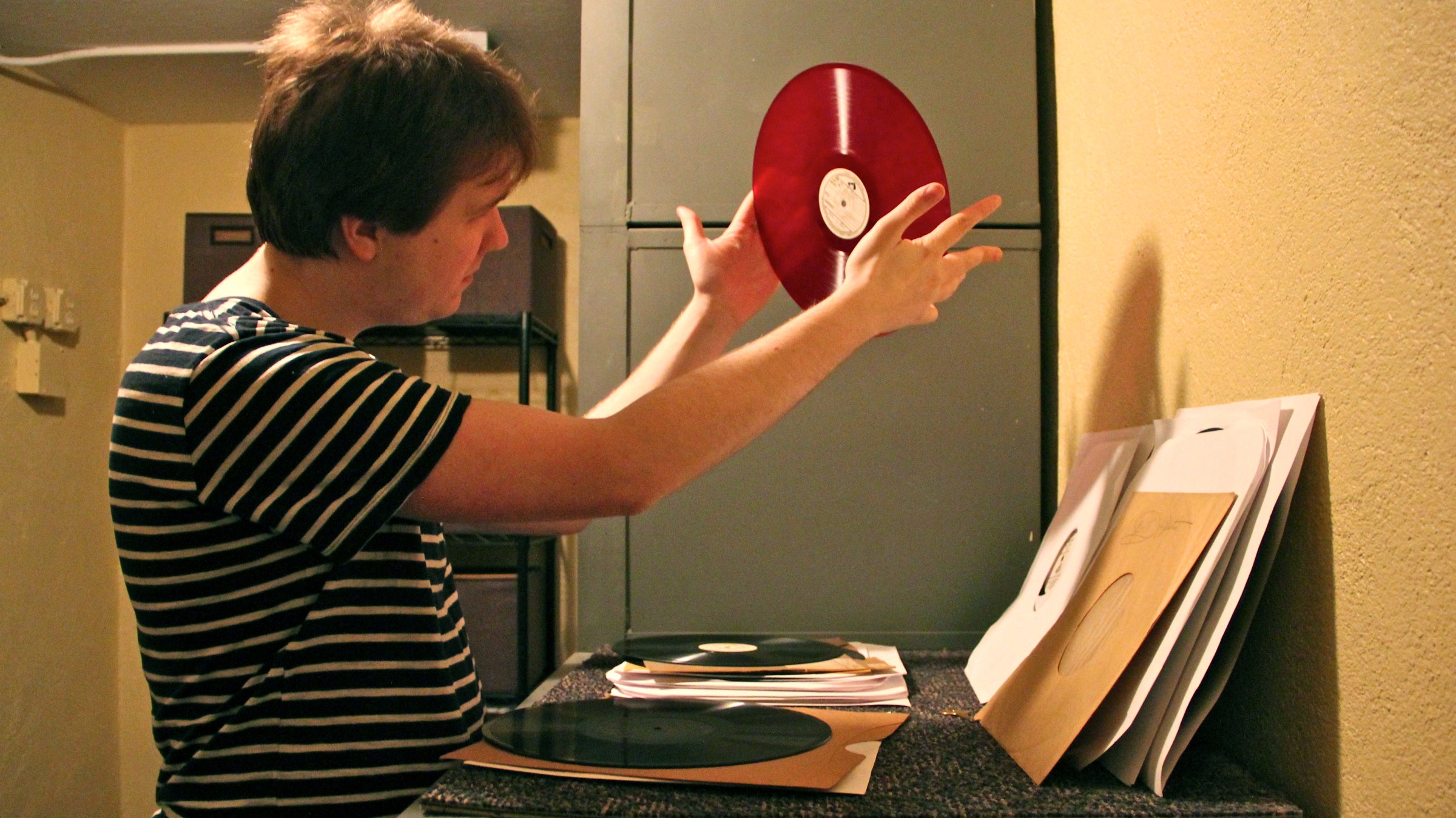  Graham Alexander looks through some of the old Victor records stored in the Vault, a bank building in Berlin, N.J., that he has transformed into a recording studio. (Emma Lee/WHYY) 